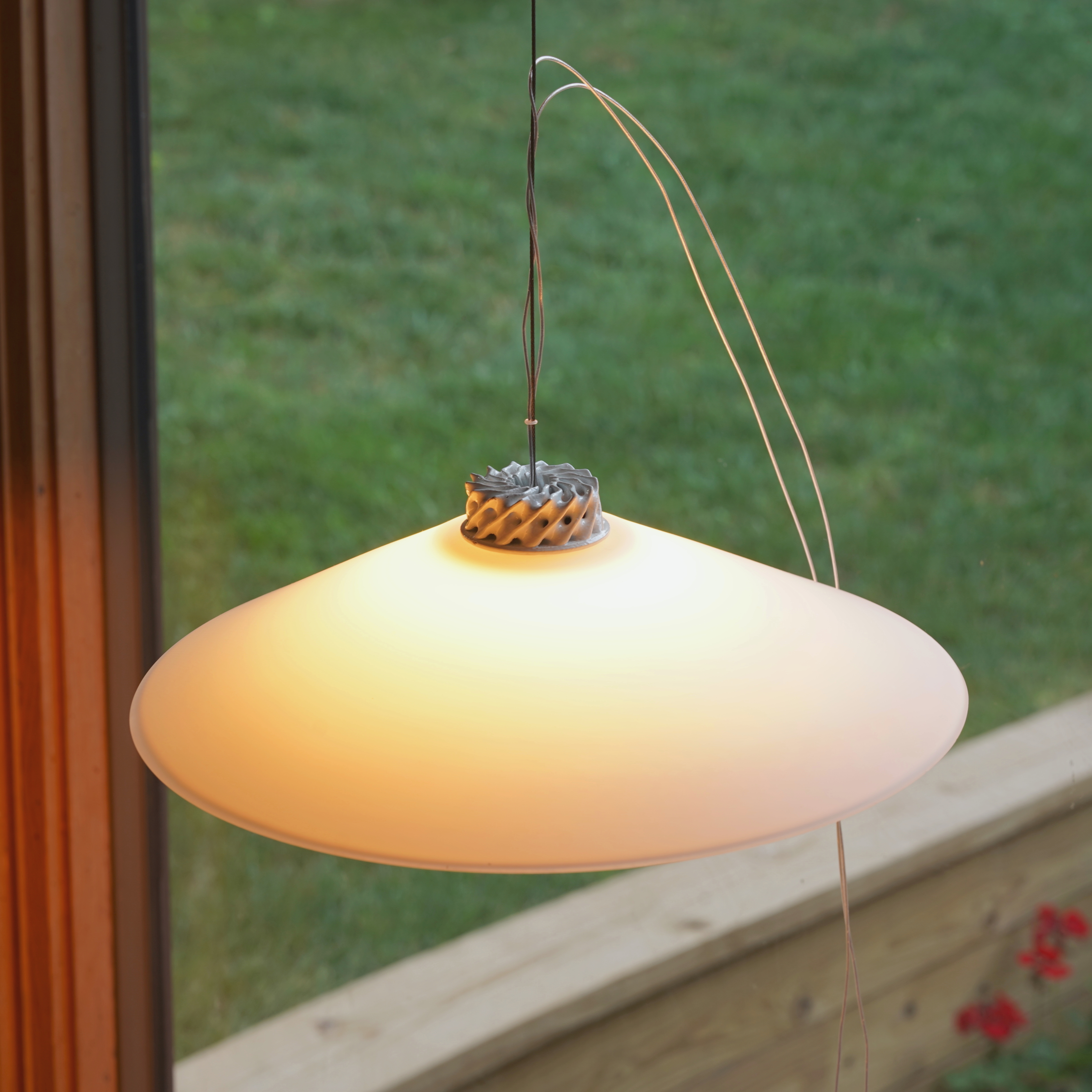 cos.x pendant lit, twisted TPMS lattice crown catching the glow at the shade edge